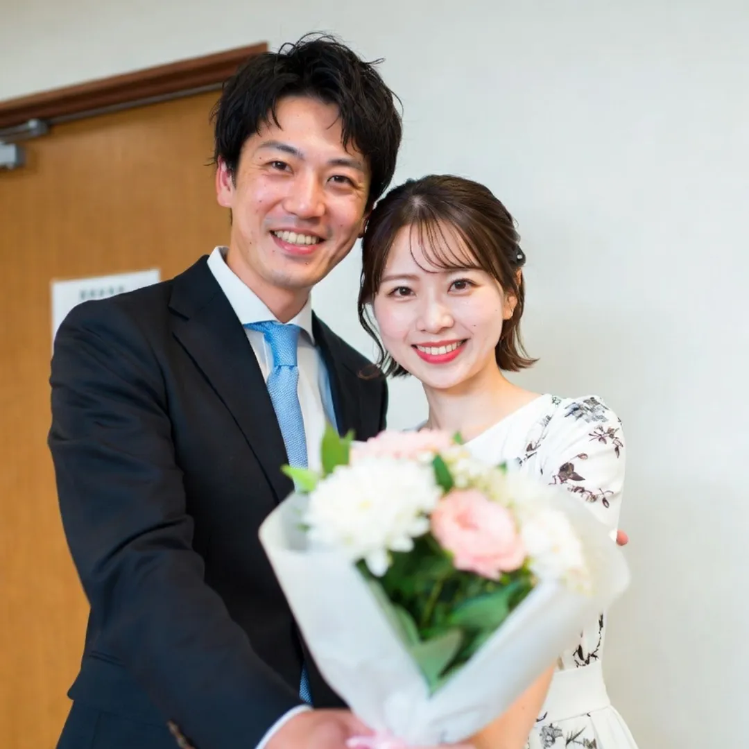 成婚お祝いの花束を手にした成婚カップルの記念写真｜結婚相談所Sweet Color